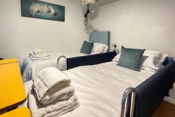 beds with hoist and side rails up